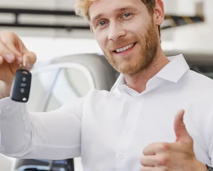 Happy customer with the keys to his new car.