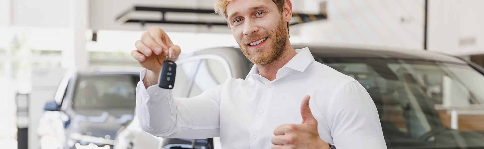 Happy customer with the keys to his new car.