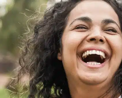 Mother and daughter laughing whilst playing outside