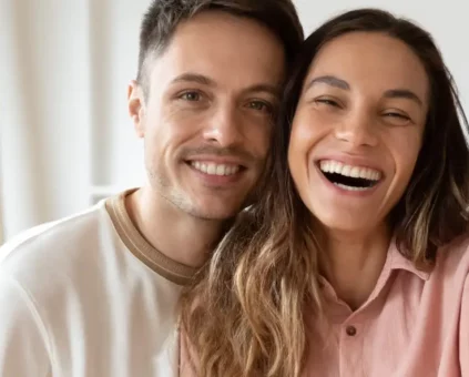 Happy couple holding the keys to their first home