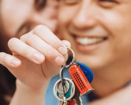 Happy couple picking up their new home keys