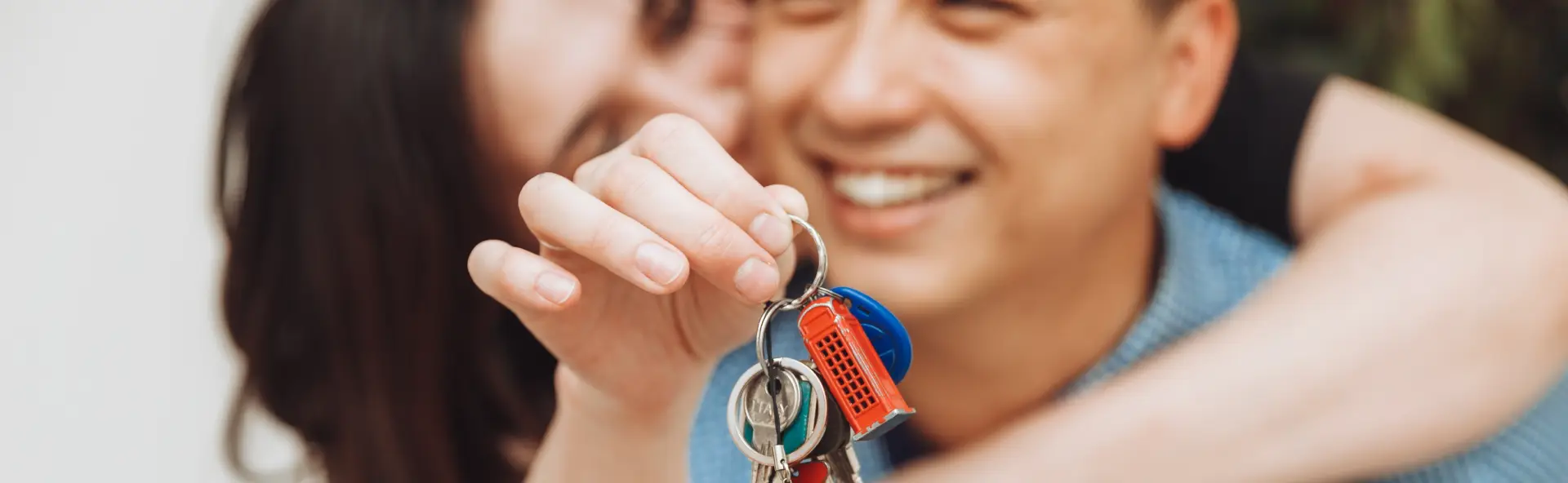 Happy couple picking up their new home keys