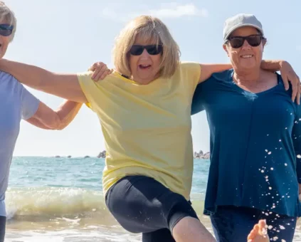 3 middle aged ladies enjoying the beach together