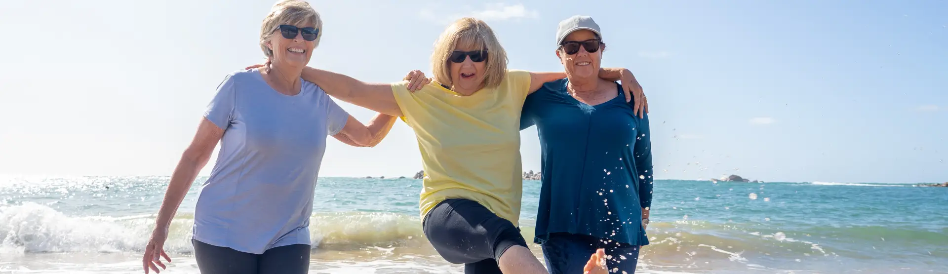 3 middle aged ladies enjoying the beach together