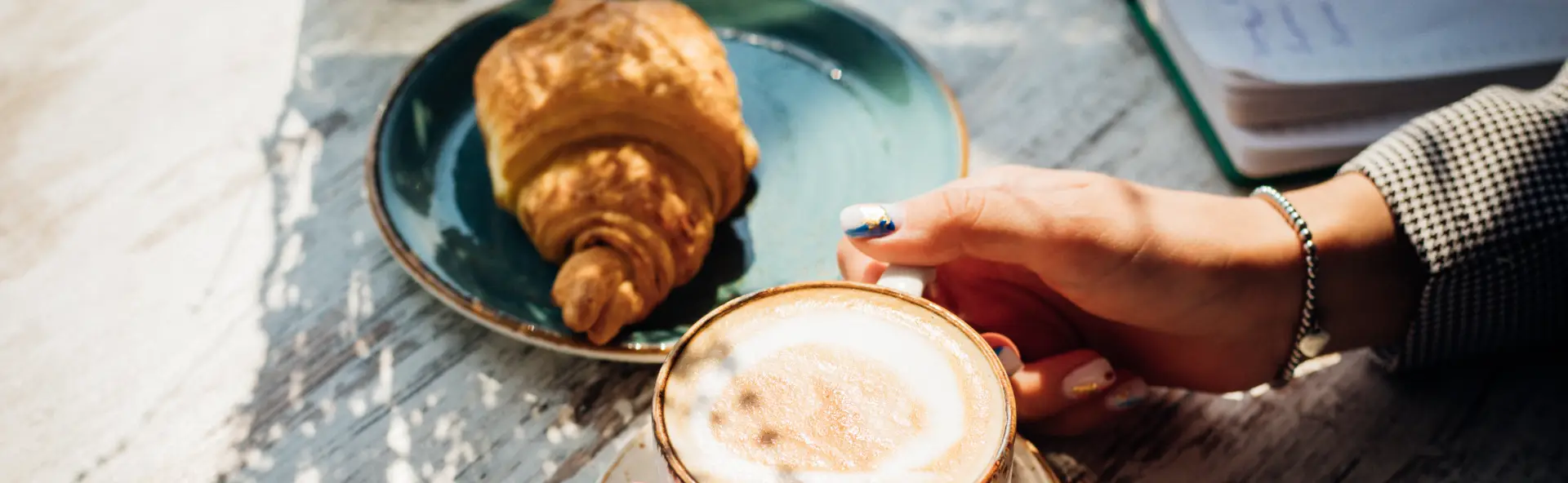 Croissant placed next to coffee