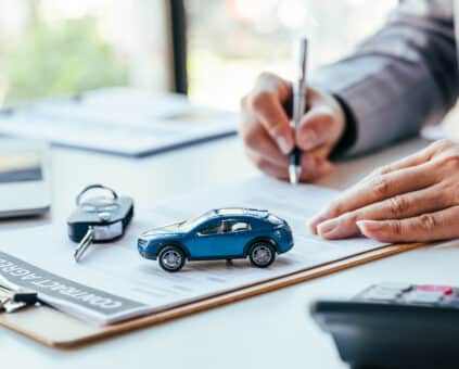 Man signing car insurance document or lease paper. Writing signa