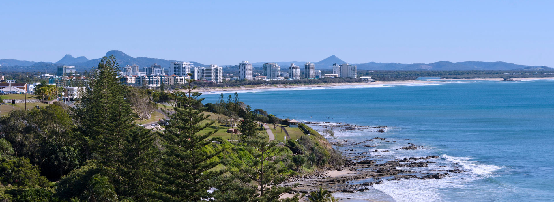 Maroochydore coastline with ocean, beach, and mountains.