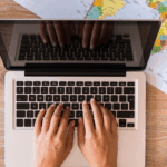Person on their laptop about to start looking for a travel loan