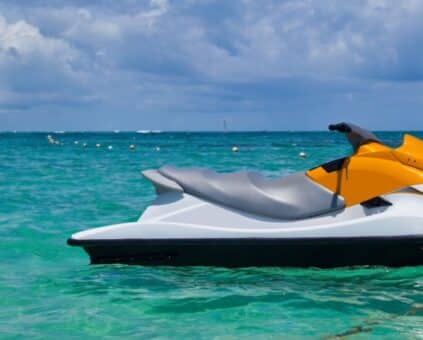 White and orange jet ski sitting in the water after getting finance