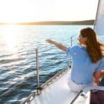 happy family on their boat in crystal clear waters after securing boat finance