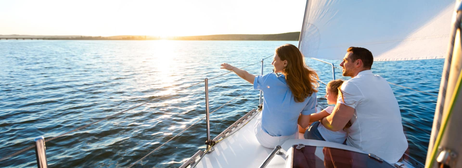 happy family on their boat in crystal clear waters after securing boat finance