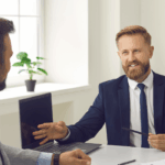 Broker in office consulting with couple at office desk, providing personalised loan guidance and financial solutions