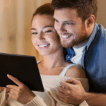 Couple reviewing personal loan application on tablet at home