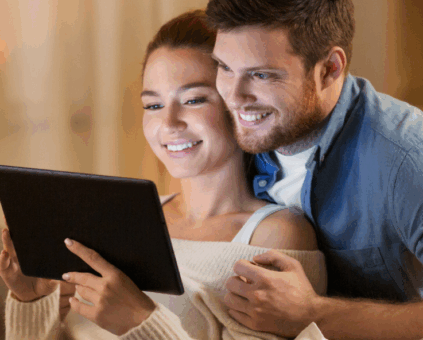 Couple reviewing personal loan application on tablet at home