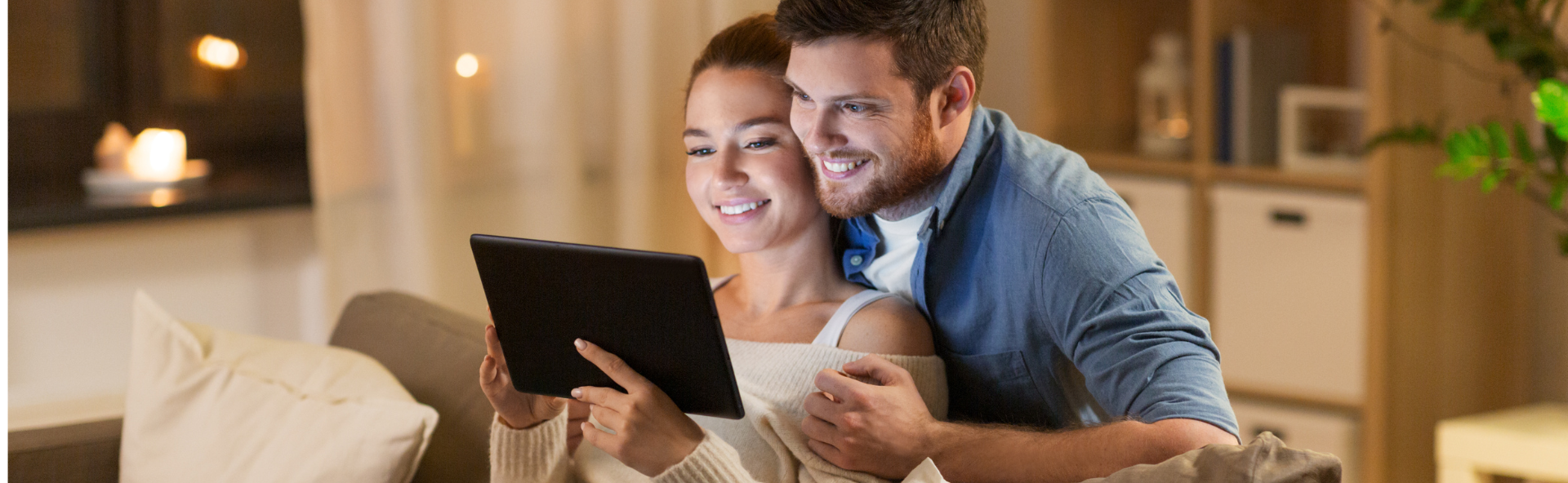 Couple reviewing personal loan application on tablet at home