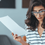 Woman reviewing bills and debt consolidation options at home