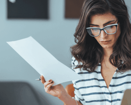 Woman reviewing bills and debt consolidation options at home