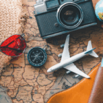 Travel accessories including camera, passport, plane model, and map representing vacation planning with travel loans
