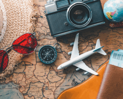 Travel accessories including camera, passport, plane model, and map representing vacation planning with travel loans