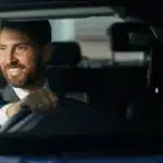 Smiling self-employed businessman driving his car, financed through a low doc car loan