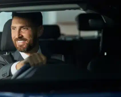 Smiling self-employed businessman driving his car, financed through a low doc car loan