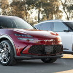 Two Genesis GV60 electric SUVs in red and white parked at an Australian dealership, representing EV finance options available through Fox Finance Group.
