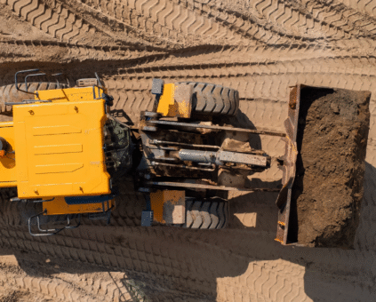 Yellow construction equipment on job site, representing business equipment financing