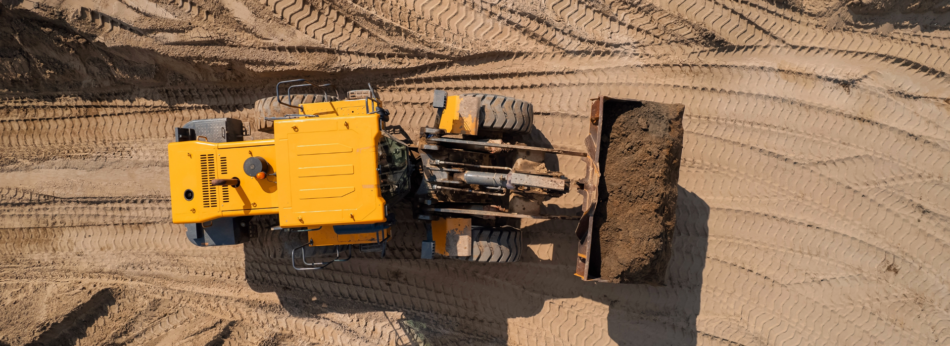 Yellow construction equipment on job site, representing business equipment financing