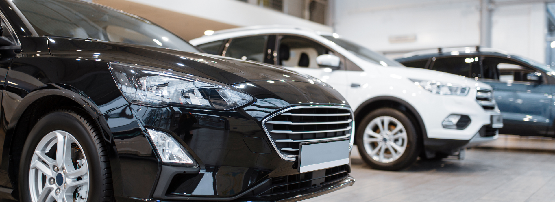 cars on display at a dealership showroom, representing car loan options