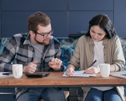 Person comparing various finance options. including advertised car loan rates and their higher comparison rate that includes fees