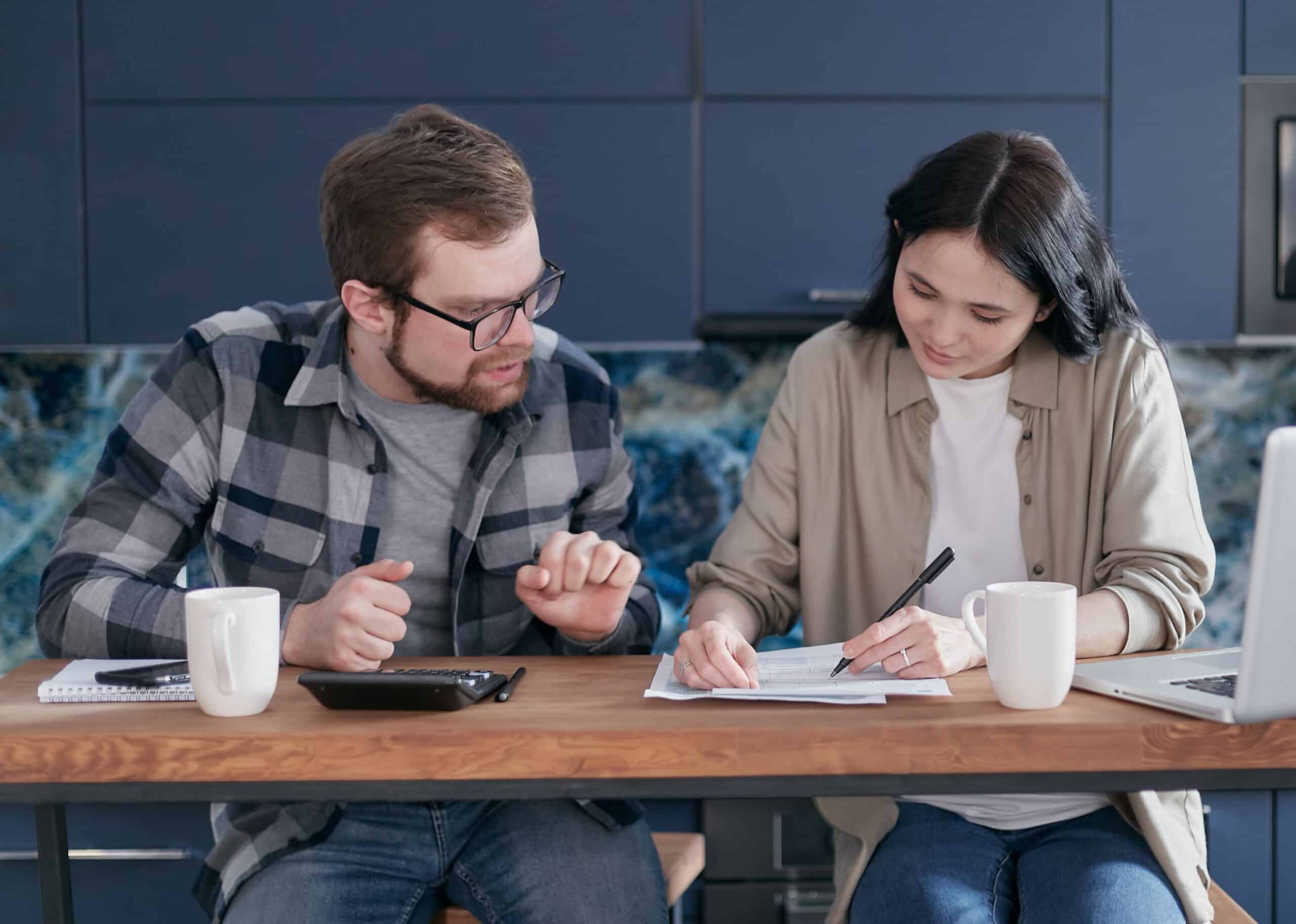 Person comparing various finance options. including advertised car loan rates and their higher comparison rate that includes fees