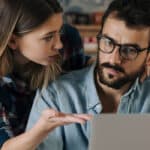 Couple reviewing bills on a laptop