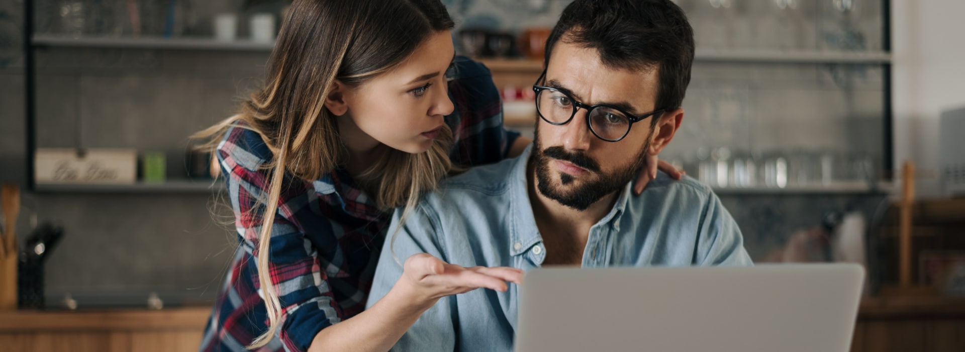 Couple reviewing bills on a laptop